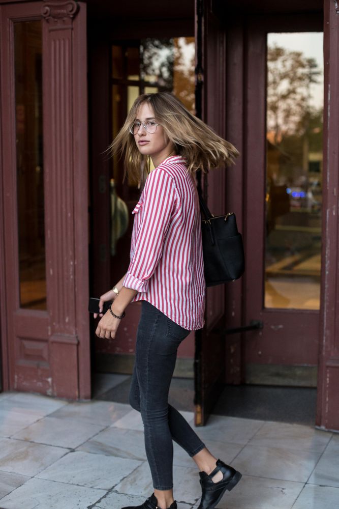 Woman in smart casual wear turning around as she walks through a door