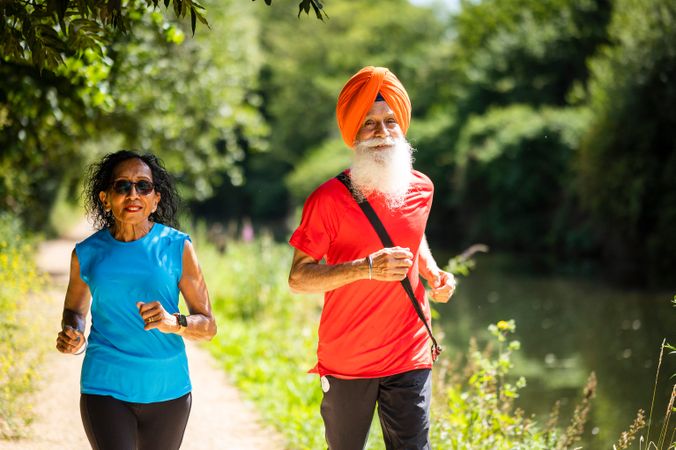 Mature Sikh couple jogging on nice day
