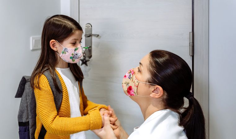 Mother advising daughter about coronavirus precautions