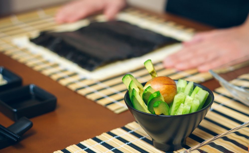 Side view of avocado and cucumber bowl ready to prepare sushi