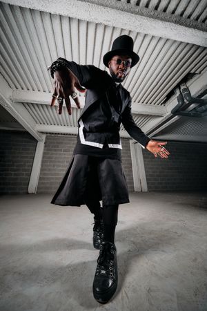 Stylish Black man dancing in garage