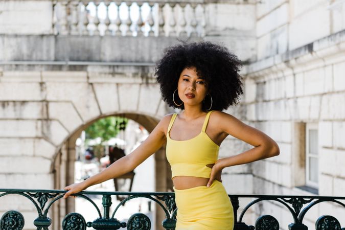 Stylish female leaning on railing outdoors