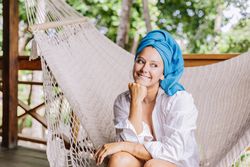 Woman in turban resting in hammock