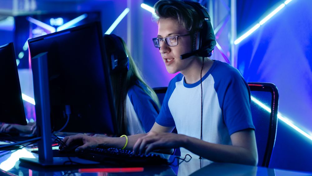 Shot of a Gamer Team Captain Giving Commands into Microphone.