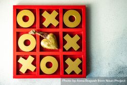 St. Valentine day card concept with gold heart ornament in center of tic-tac-toe game 41ldkZ