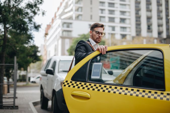 Businessman taking a taxi to commute to office
