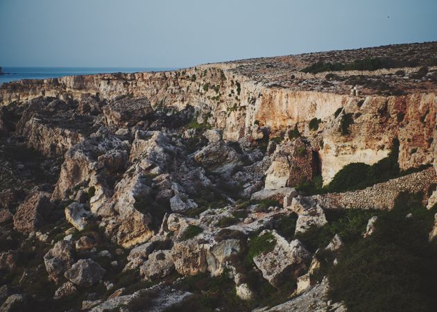 Looking over rocky cliffs of Malta over the Mediterranean