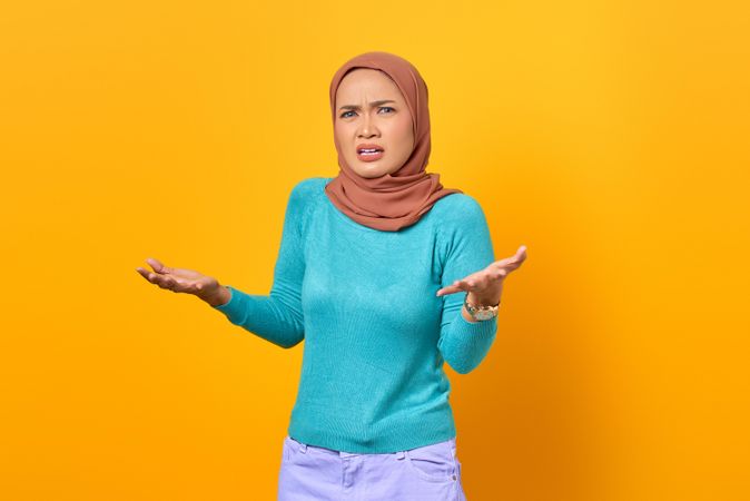 Questioning Muslim woman with arms out
