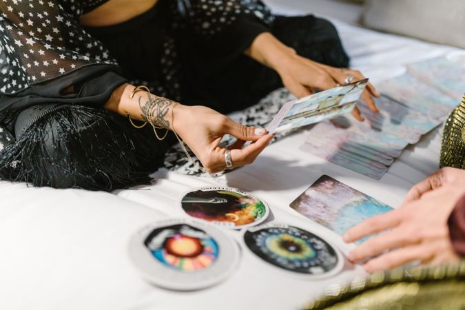 Cropped image of woman reading Tarot cards