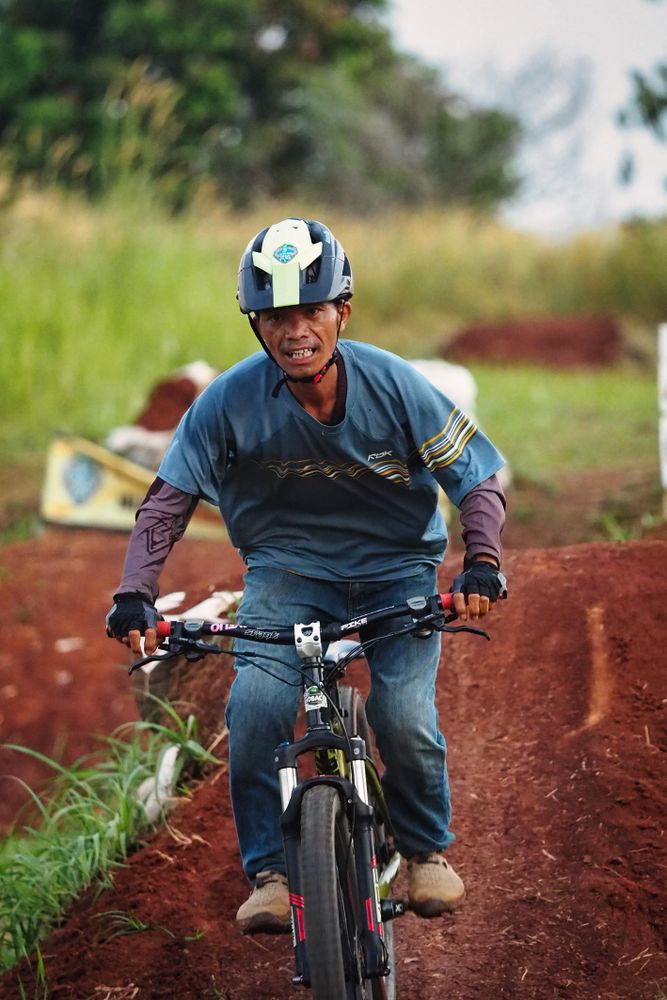 Man riding a bike on dirt road