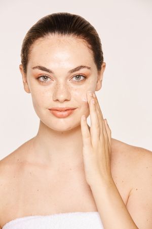 Amiable female taking care of face