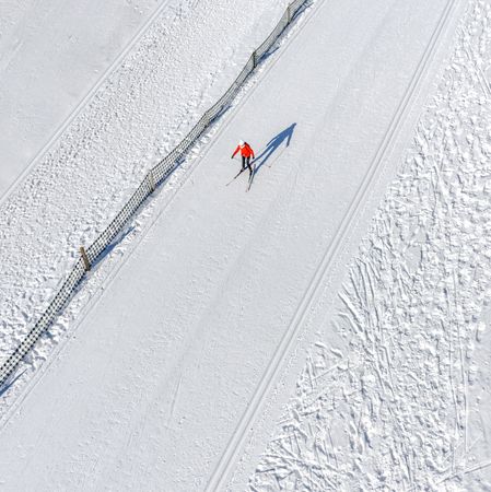 Skier running on the track. Snow field. Aerial.