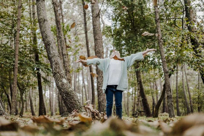 Smiling girl between meadow with dry leaves