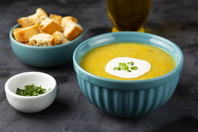 Bowl with pumpkin soup on the table.