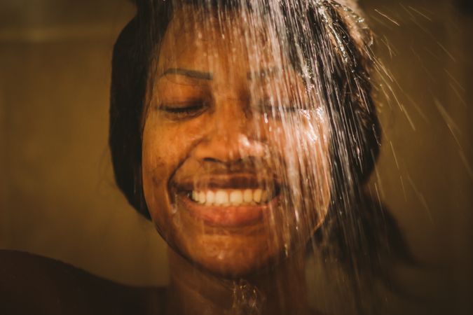 Cheerful female taking shower