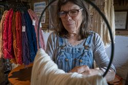 Farmer Dominique Herman preparing wool to sell