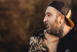 Happy couple hugging near tree in park