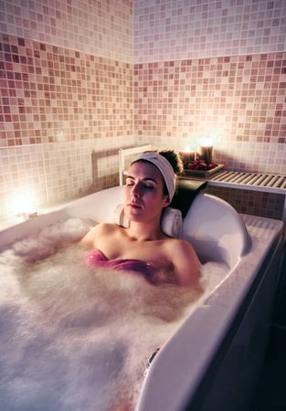 Woman relaxing in spa bath