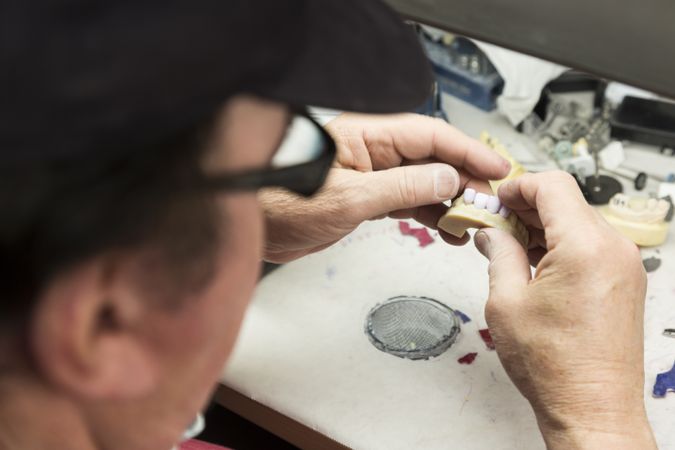 Dental Technician Working On 3D Printed Mold For Tooth Implants