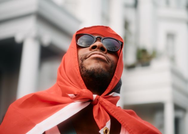 London, England, United Kingdom - August 28, 2022: Black man draped in Trinidad & Tobago flag