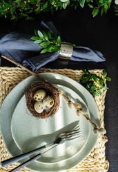 Easter table setting with branch on plate with decorative bird nest