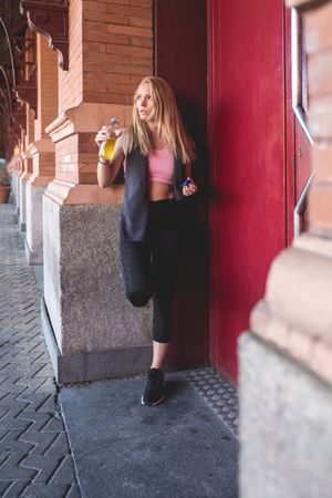 Woman drinking isotonic drink while having a break