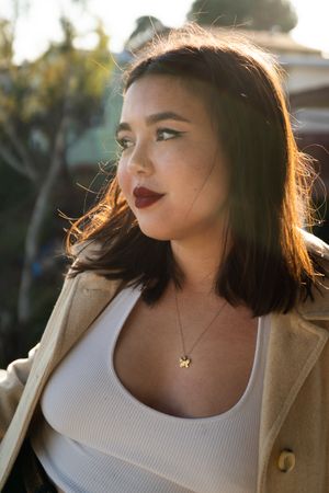 Close up of pretty woman with straight hair looking away outside