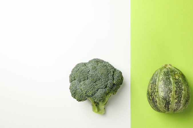 Zucchini and broccoli on two tone background