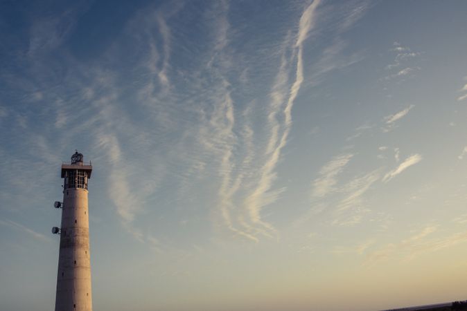 Round grey lighthouse tower rising up to sky