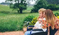 Mature woman in a wheelchair with her daughter