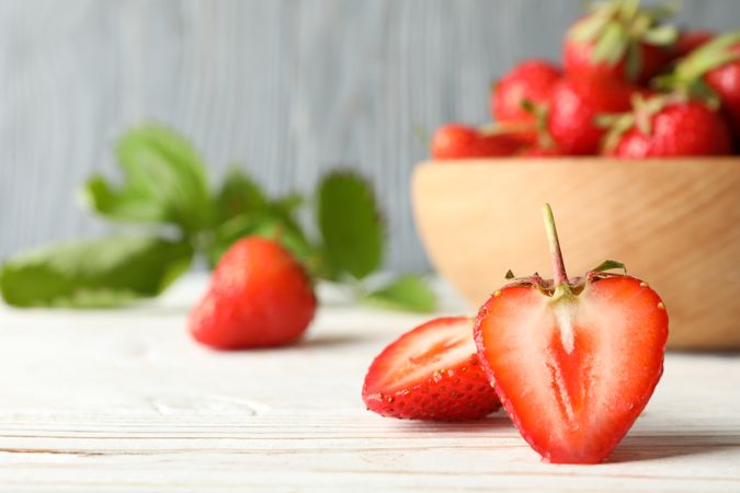 Bowl with tasty strawberry on wooden table. Summer berry