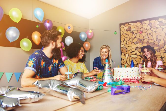 Group of four friends celebrating for a birthday party