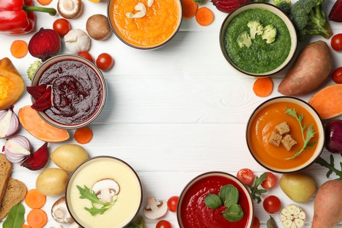 Circle of soups with copy space on wooden table