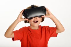 Mesmerized girl in VR glasses and gesturing with hands on goggles