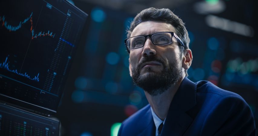 Adult Man Wearing Glasses, Researching Investment Possibilities for International Business Corporations