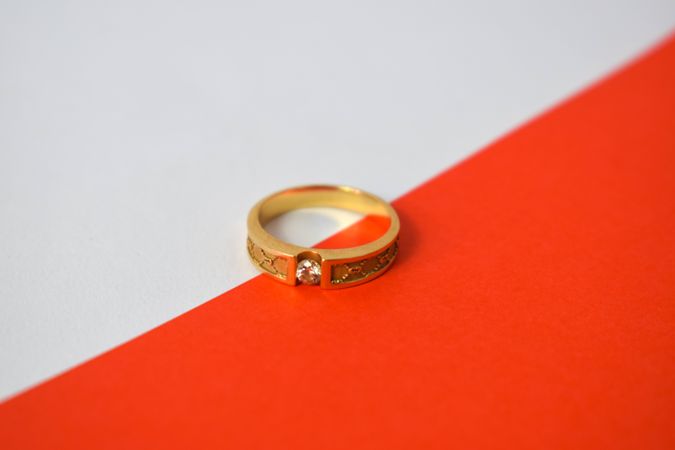 One diamond gold ring on duotone background