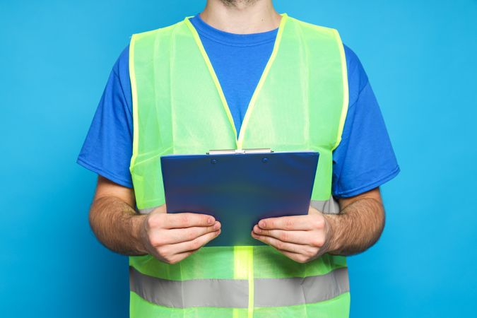 Civil engineer with clipboard on blue background