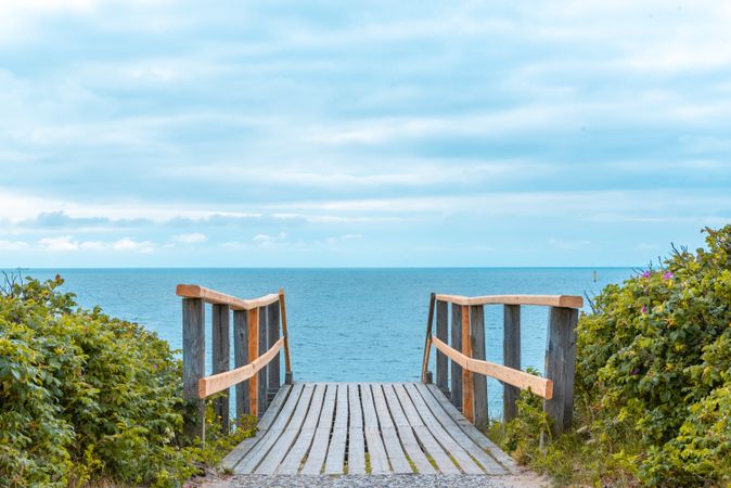 Summer landscape on Sylt island, in Germany, with wooden stairs leading to the beach and the North Sea