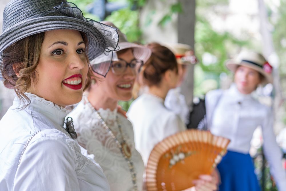 Vintage female friends speaking in garden