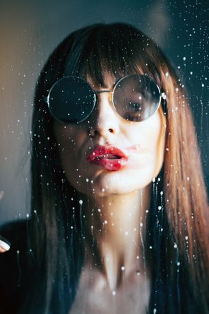 Stylish woman kissing glass