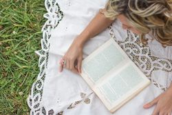 woman with book on the grass