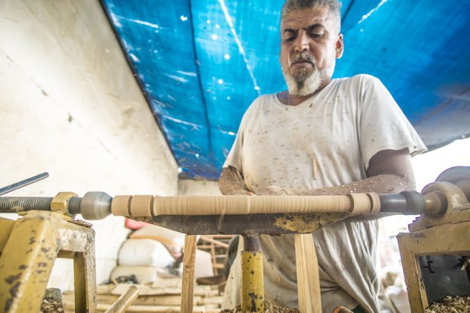 Man using woodworking machine at workplace