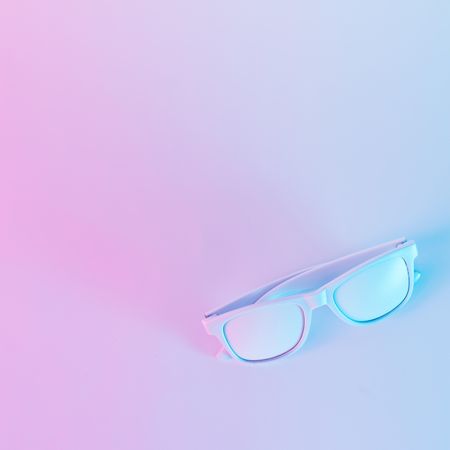 Sunglasses in vibrant bold gradient purple and blue holographic colors
