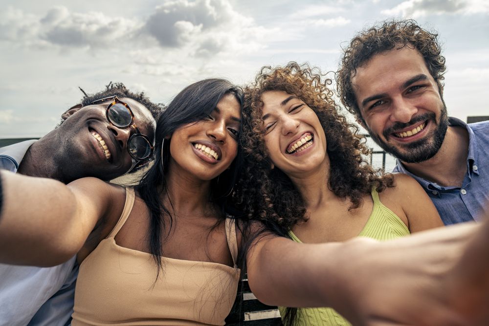 Group of happy friends taking a selfie on vacation
