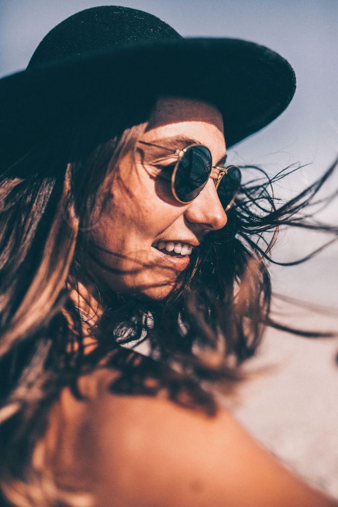 Portrait of a young woman in a hat outdoors