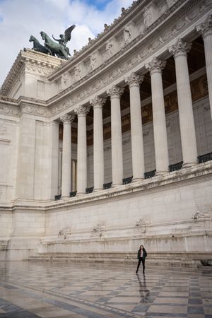 Tourist standing near old building with columns