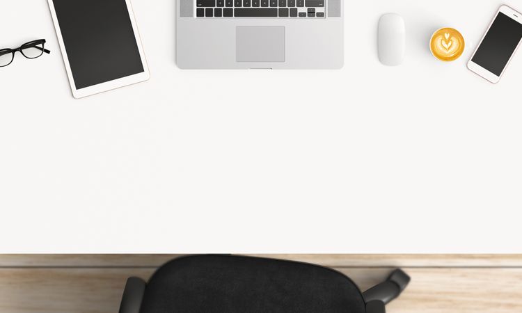 Modern workplace with coffee cup and smartphone or laptop copy space on office table background. Top view. Flat lay style