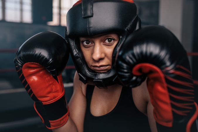 Female boxer in head gear & gloves