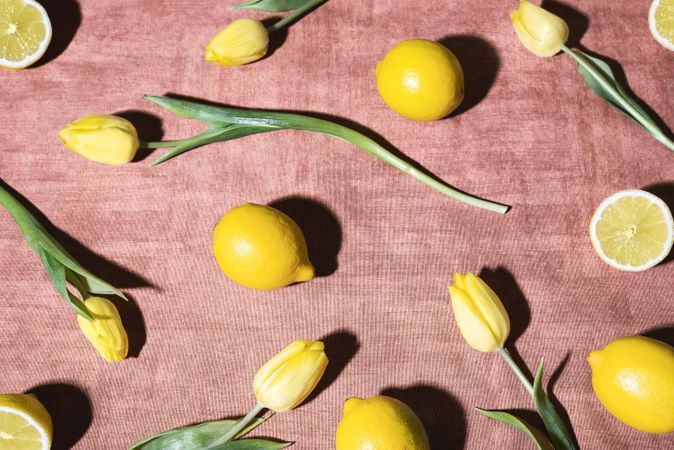 Lemons and yellow tulips on a retro orange tablecloth