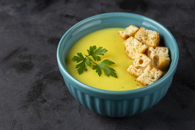 Bowl with onion soup and croutons on the table.